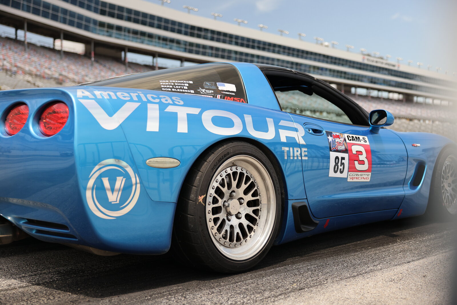 Teal C5 Corvette with VITOUR sponsor decals staged on the track at LS Fest Texas