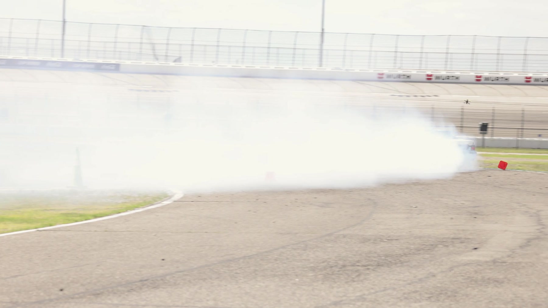 Yellow Corvette laying down a burnout at Texas Motor Speedway