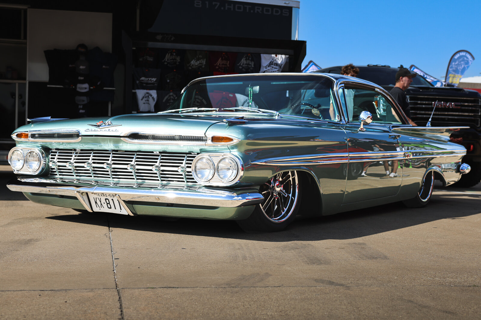 Vintage Chevy Impala parked in the cruise area at LS Fest Texas, classic side profile