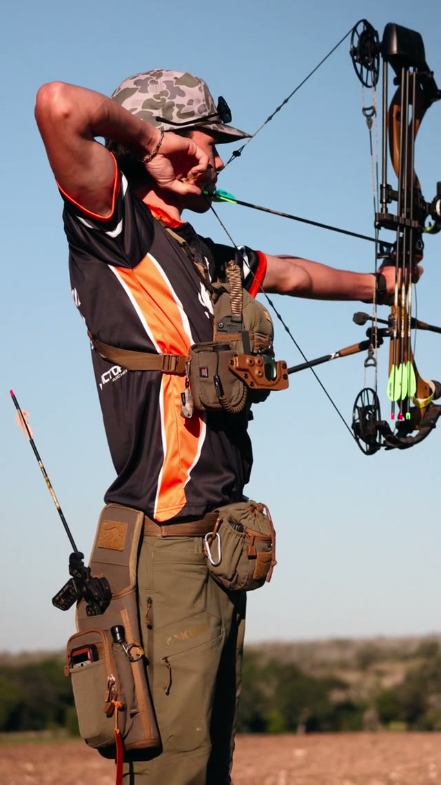 Archer at full draw on a 3D archery range